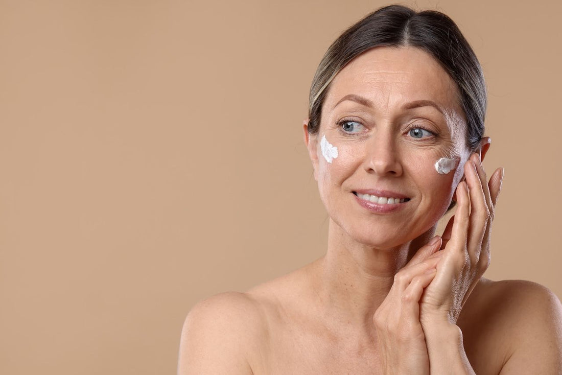 applying moisturizer to her cheeks as part of her skincare routine